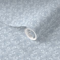 a blue and white wallpaper with swirls on it