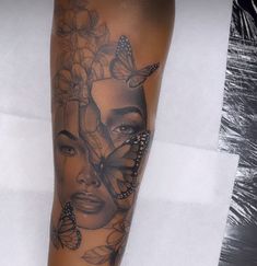 a woman's face with butterflies and flowers on her leg, as if she was wearing a butterfly tattoo