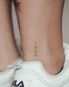 a woman's foot with a small tattoo on her left ankle and the word love written in cursive font