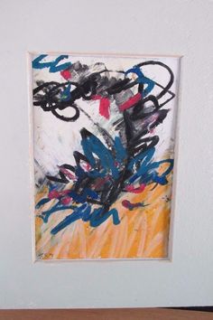 an abstract painting is hanging on the wall