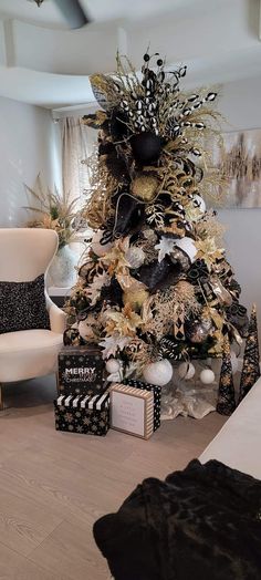 a white christmas tree with black and gold decorations