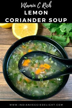 a bowl of lemon coriander soup with a spoon in it on a wooden table