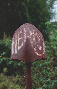 an old rusted metal object with the word help painted on it's side