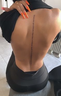 the back of a woman's body with an inscription on it