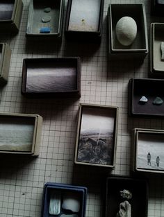 there are many different boxes on the floor with pictures in them and one is empty