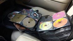 a bunch of cds sitting on top of a car seat