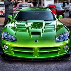 a green sports car parked in a parking lot