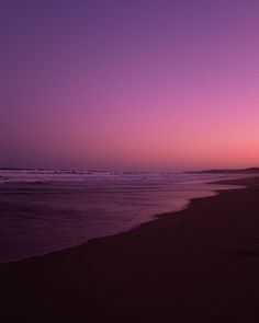 the sun is setting over the ocean and beach