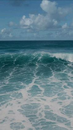 the ocean is blue and green with white foamy waves on it's surface