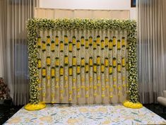 the backdrop is decorated with yellow flowers and greenery for a wedding ceremony or reception