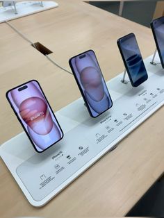 three iphones are on display at an apple store