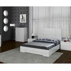 a bedroom with white furniture and gray walls