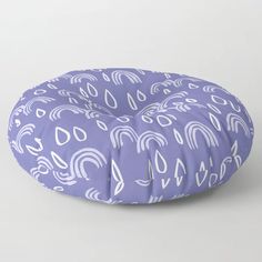 a purple and white pattern on a round floor pillow