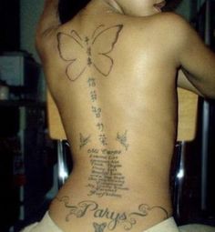 a woman with a butterfly tattoo on her back