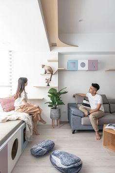 a man and woman sitting on a couch in a living room next to each other