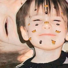 a young boy has his face painted with animal tracks and paw prints on it's forehead