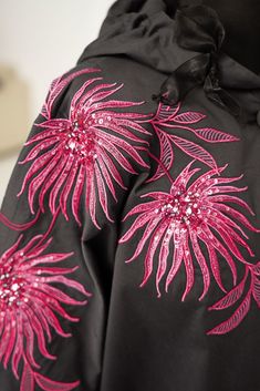 a black jacket with pink flowers on it