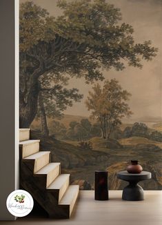 a staircase leading up to a wall with a painting on it and a vase next to it