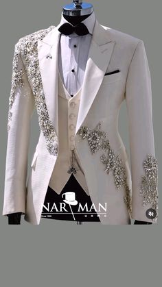 a white tuxedo with silver sequins on the lapel