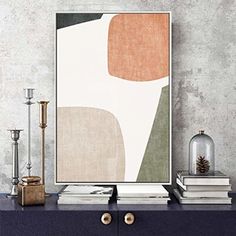 an art print on a wall next to a dresser with candles and other decor items