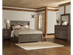 a bedroom scene with focus on the bed and dresser