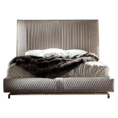 an upholstered bed with fur on it