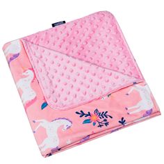 a pink blanket with unicorns on it