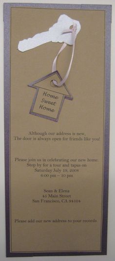 a wedding card with a house and key on the front, attached to a white ribbon