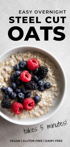 a bowl of oatmeal with berries and raspberries in it on a table