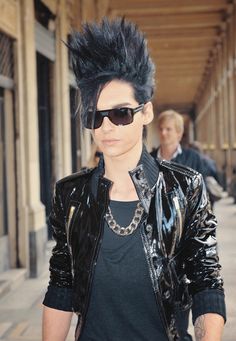 a young man with black hair and sunglasses