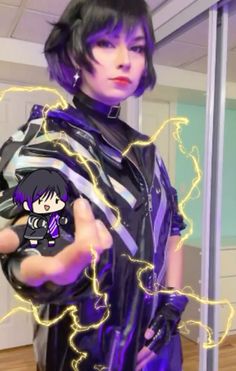 a woman with black hair and purple makeup holding a cell phone in her right hand