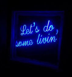 a blue neon sign that says let's do some livin in the dark