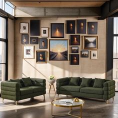 a living room filled with green couches and pictures on the wall next to a coffee table