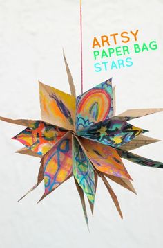 an origami star hanging from a string with the words artsy paper bag stars above it
