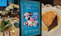 there is a piece of cake on the plate next to a sign that says let love shine gala 2013