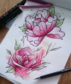 a drawing of two pink flowers on paper next to markers and pencils with marker pens