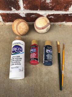 the contents of a baseball, paint, and other items are laid out in front of a brick wall