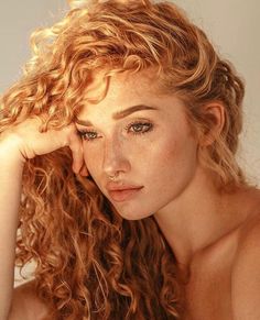 a beautiful young woman with long curly hair