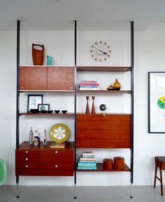 a room with some shelves and a clock on the wall