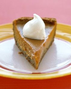 a slice of pumpkin pie with whipped cream on top