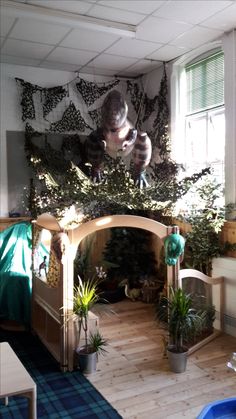 a living room filled with lots of plants and potted plants on top of a wooden floor