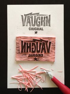 a pair of pink scissors next to a sign that says vaugh original