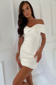 We recommend sizing up in this style. Love is a gift. Non-traditional but oh-so-romantic, this is the dress for brides looking to make a statement on their special day. Featuring an off-the-shoulder bow to flatter the décolletage, paired against a minimalist mini dress, this is a dress that plays with dimensions. Pair with our Caitlin Diamante Rope Heels to complete the look. This dress is considered a Micro Mini Dress and measures shorter than 82cm from shoulder point FEATURES: Off-shoulder nec Simple Mini Dress, Bow Mini Dress, Wrapped Skirt, Mini Wedding Dresses, Satin Short, Off Shoulder Fashion, Prom Dress Shopping, Green Prom Dress, Grad Dresses