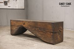 a wooden bench sitting on top of a cement floor