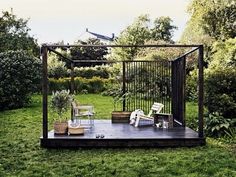 an outdoor living area with chairs and plants