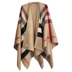 Step into a world of elegance with the Burberry 'Charlotte' Wool Poncho Cape. This luxurious cape is expertly crafted from the finest Merino wool, offering unmatched comfort and quality. The cape features a unique two-sided design; one side is adorned with a sleek, solid color, while the other boasts Burberry's iconic check pattern.Measurements:- Size: 55 inches x 55 inchesFeatures:- Reversible design for versatile wear- Shawl collar and open front for a relaxed, oversized fit- Unique handkerchi Burberry Poncho Capes, Burberry Poncho, Burberry Cape, Burberry Classic, Burberry Scarf, Vintage Burberry, Wool Poncho, Wool Cape, Burberry Women