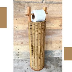 a wicker toilet paper roll holder on a wooden wall