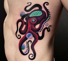 an octopus tattoo on the side of a man's stomach