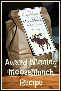 a brown bag sitting on top of a wooden table next to a sign that says award winning mooseminch recipe
