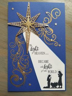 a blue and gold christmas card with a shining star on the top that says, light of heaven because he came to the light of the world